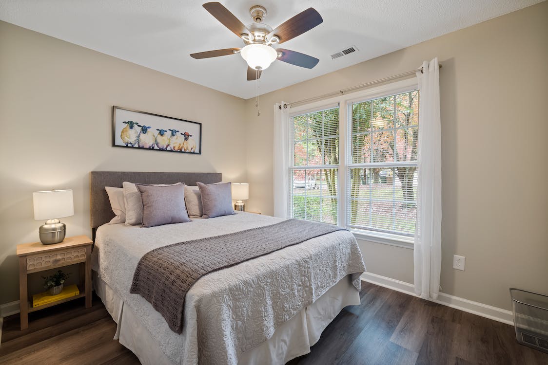  A bedroom with a ceiling fan