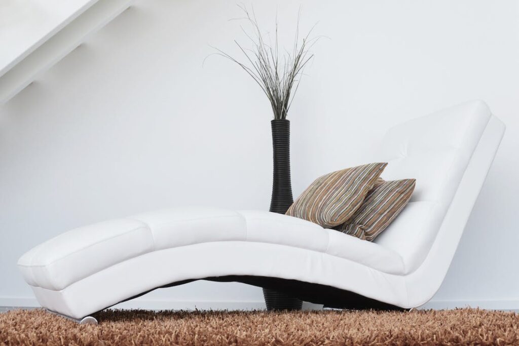 A white chair for relaxing, representing some of the innovative bedroom furniture for better rest. 