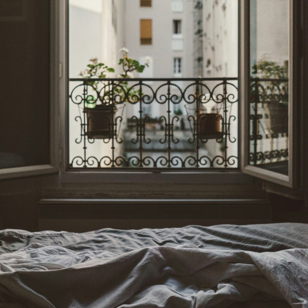 Picture of an open window above a bed